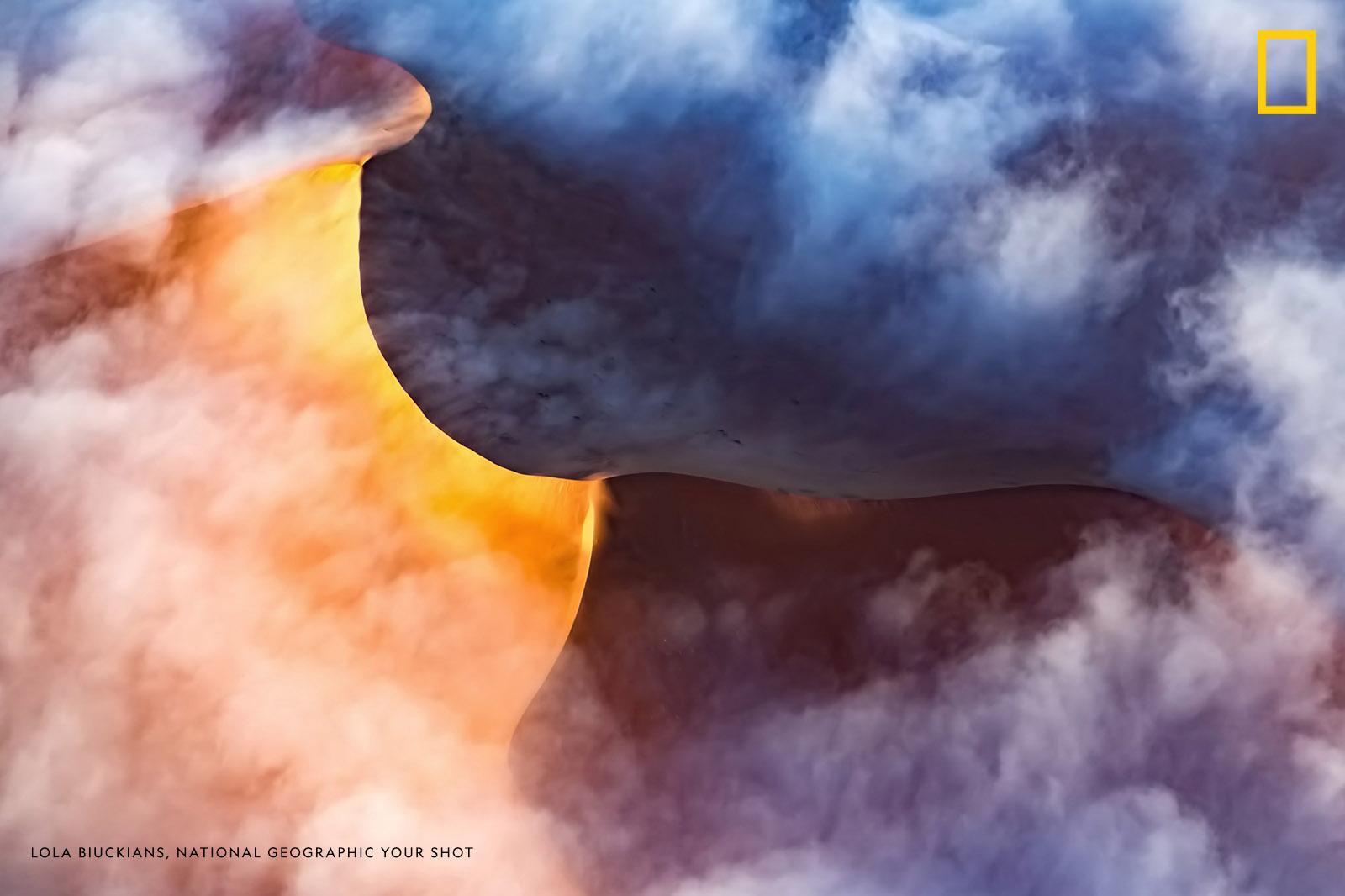 "Our pilot said he has not seen anything like this in his almost 20 years of flying this morning run," writes Your Shot photographer Lola Biuckians, who captured this dreamy aerial scene of fog rolling off sand dunes. https://on.natgeo.com/2Zqumz9